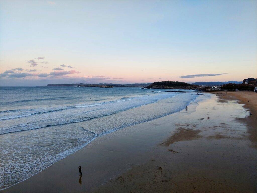 playa del sardinero sunset Waves and person walking