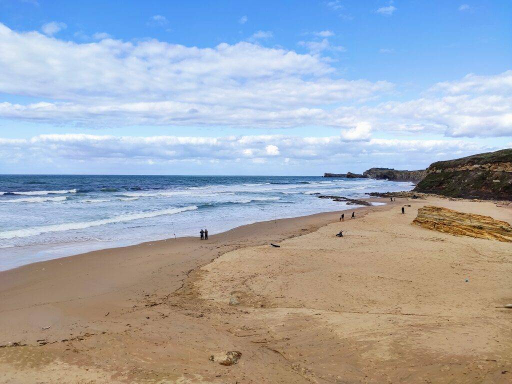 Liencres beach cantabria golden sand waves and blue cloudy sky